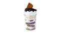 A Breaking Batter Cake Jar with Vanilla Cake, Marshmallow Whipped & Chocolate Frosting, Hershey’s Syrup, Chocolate Chips and Graham Crackers in a Mini Mason Jar