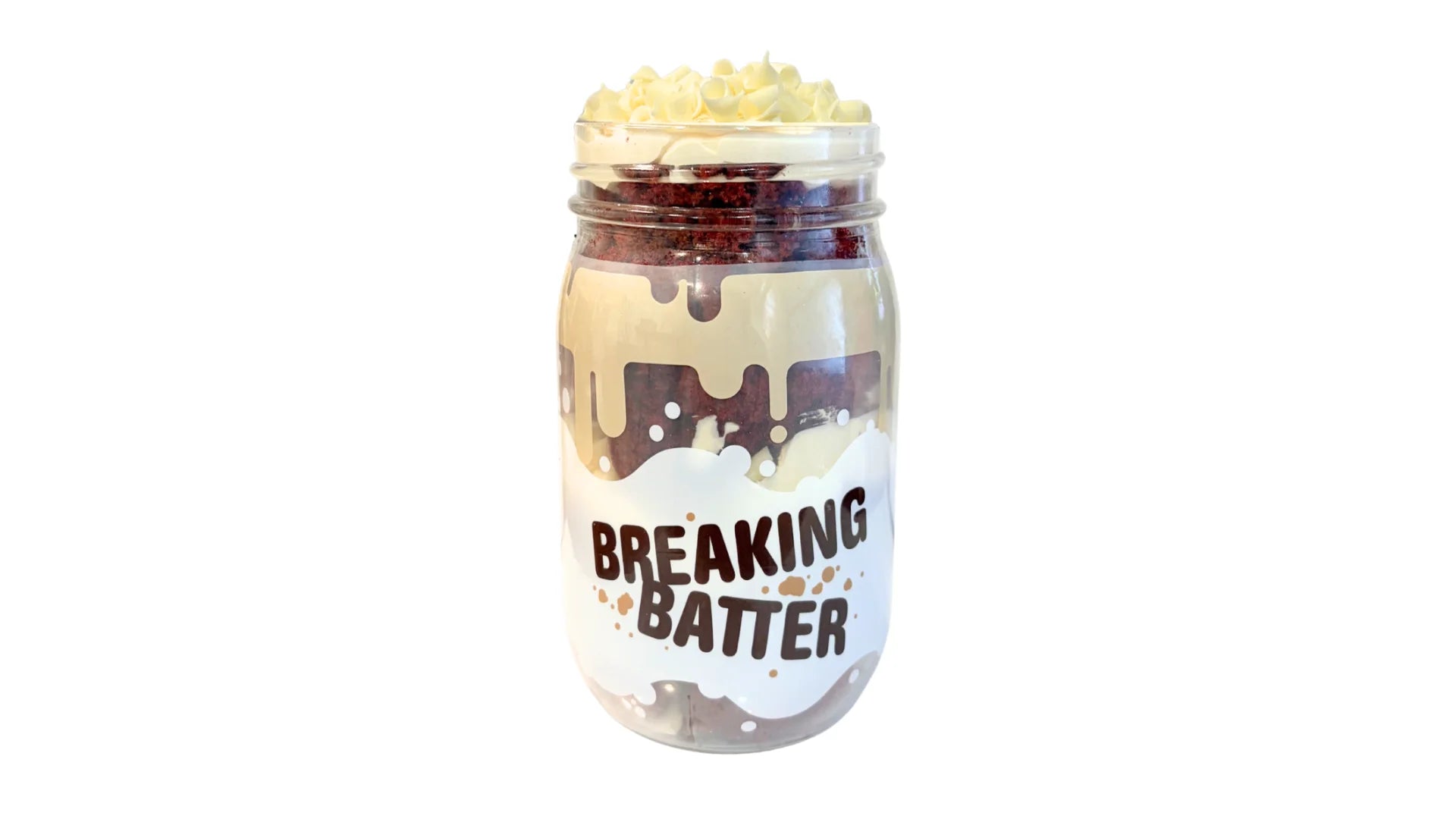 A Breaking Batter Cake Jar with Red Velvet Cake, Cream Cheese Frosting and White Chocolate Curls.