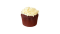 A Red Velvet Cupcake Topped with Cream Cheese Frosting and White Chocolate Curls.