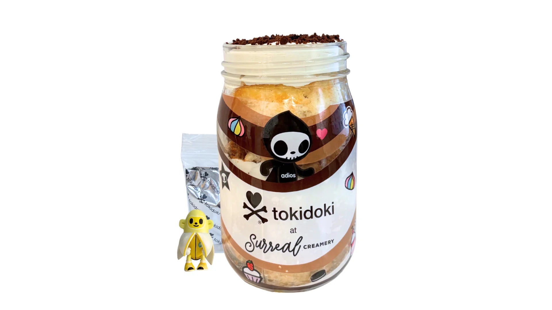 A tokidoki inspired Breaking Batter Cake Jar with Vanilla Cake, Chocolate & Marshmallow Whipped Frosting, Graham Crackers, Chocolate Chips and Chocolate Crunch. Served in a limited-edition mason jar and paired with one 1" tokidoki mystery collectible.