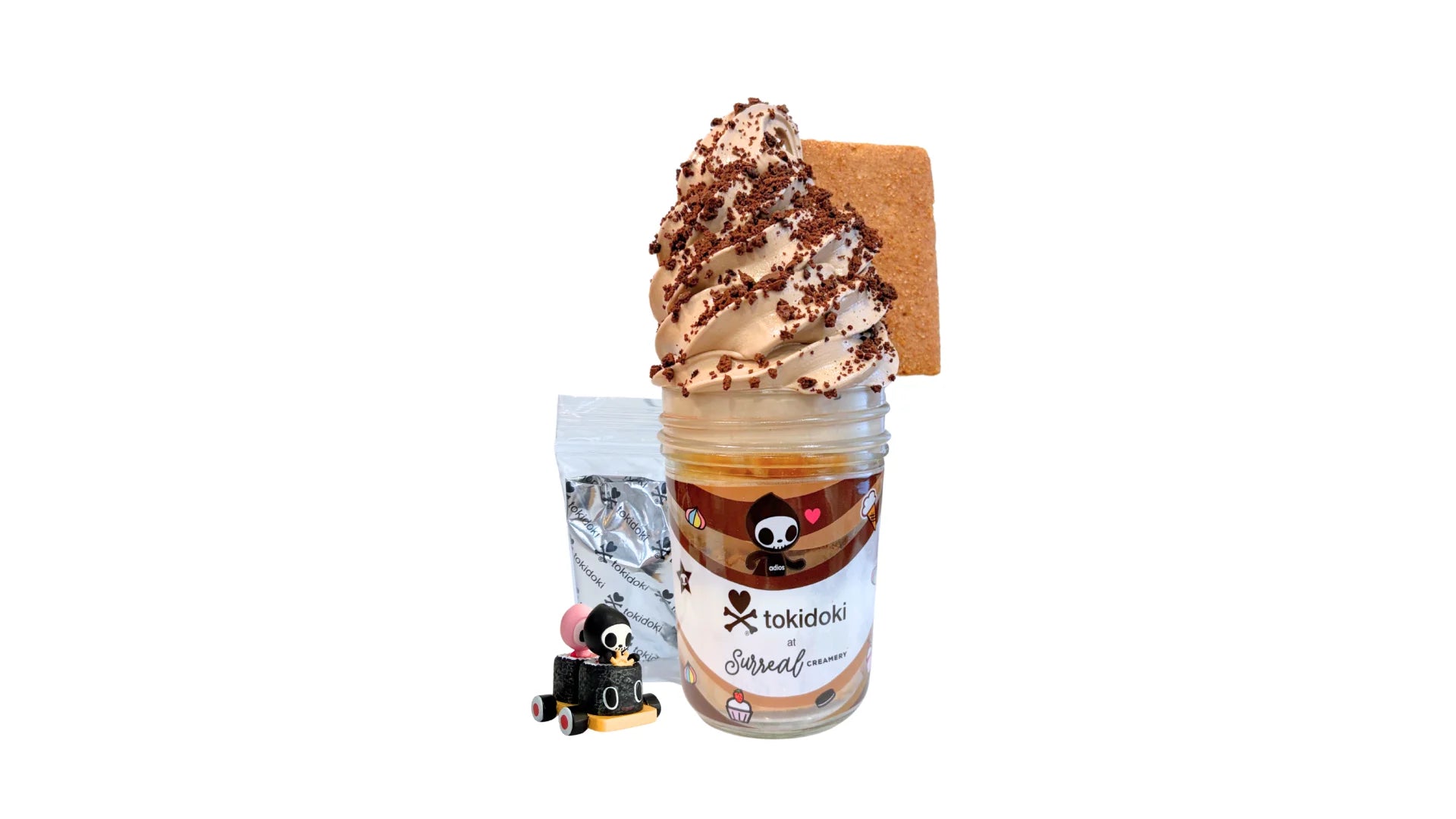 A tokidoki inspired Breaking Batter Ice Cream Cake Jar with Vanilla Cake, Chocolate & Marshmallow Whipped Frosting, Graham Crackers, Chocolate Chips, Chocolate Crunch and Chocolate Ice Cream. Served in a limited-edition mason jar and paired with one 1" tokidoki mystery collectible.