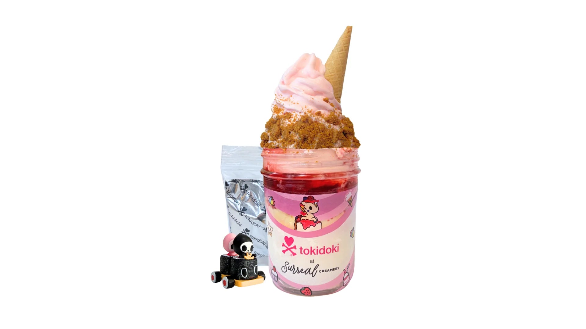 A tokidoki inspired Breaking Batter Ice Cream Cheesecake Jar with Cheesecake, Vanilla Cake, Cream Cheese Frosting, Strawberry Toppings, Graham Crackers, Strawberry Ice Cream and a Mini Cone. Comes with one 1" tokidoki mystery collectible.