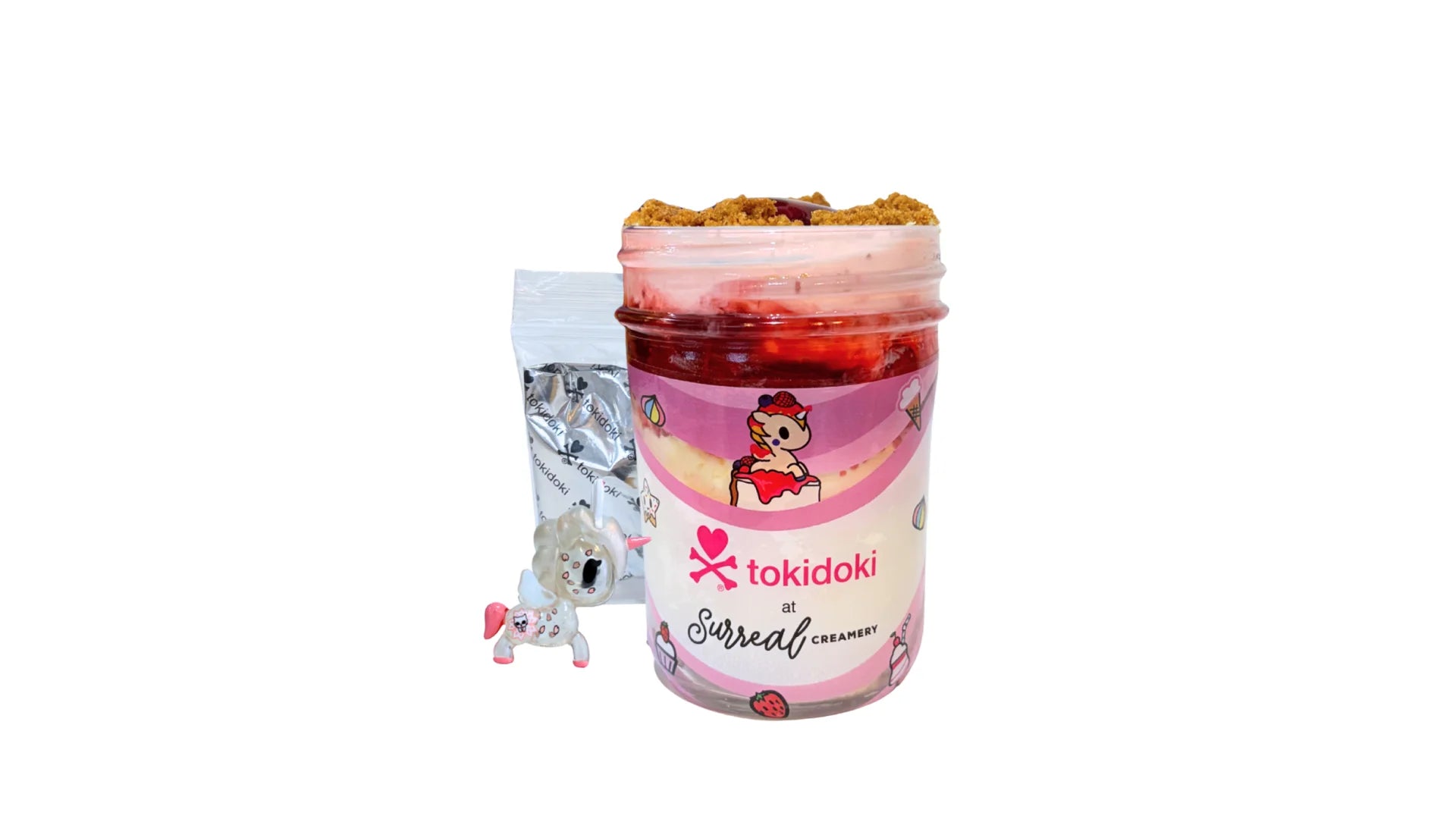 A tokidoki inspired Breaking Batter Ice Cream Cheesecake Cup with Cheesecake, Vanilla Cake, Cream Cheese Frosting, Strawberry Toppings, Graham Crackers, Strawberry Ice Cream and a Mini Cone. Comes with one 1" tokidoki mystery collectible.