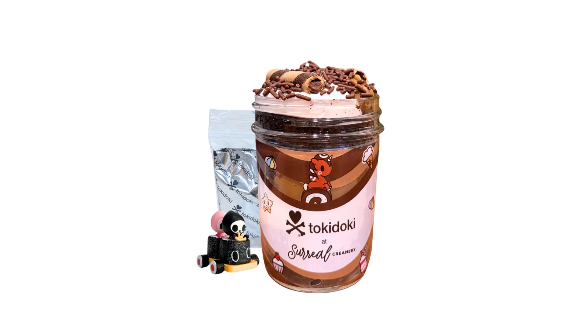 A tokidoki inspired Breaking Batter Cake Jar with Chocolate Cake, Espresso Cake, Chocolate & Marshmallow Whipped Frosting, Chocolate Sprinkles and Chocolate Straws. Served in a limited-edition mason jar and paired with one 1" tokidoki mystery collectible.