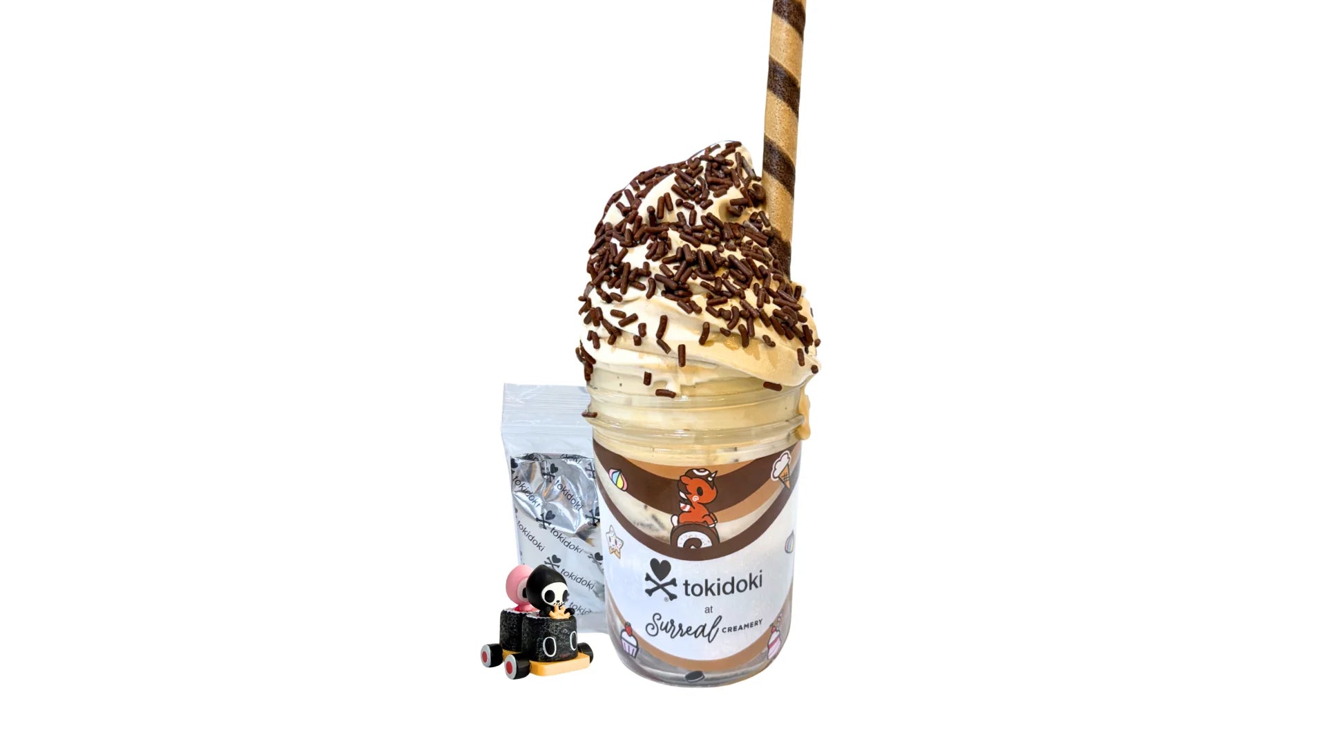 A tokidoki inspired Breaking Batter Ice Cream Cake Jar with Chocolate Cake, Chocolate & Marshmallow Whipped Frosting, Chocolate Sprinkles, Chocolate Straws, Whipped Cream and Earl Grey & Vietnamese Iced Coffee Ice Cream Swirl. Served in a limited-edition mason jar and paired with one 1" tokidoki mystery collectible.
