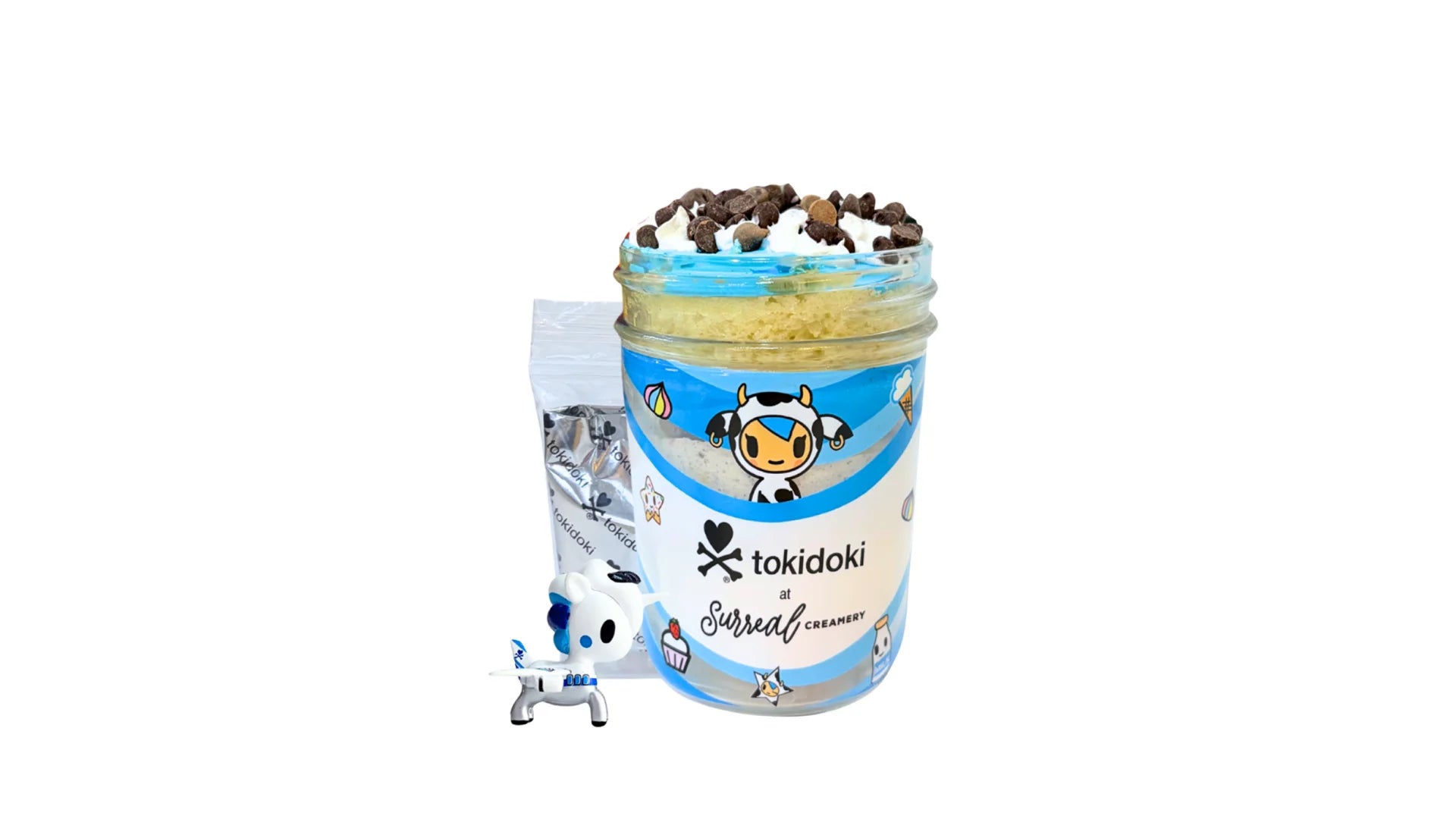 A tokidoki inspired Breaking Batter Cake Jar with Vanilla Cake, Cookies and Cream & Blue Vanilla Frosting, Chocolate Chips and Whipped Cream. Served in a limited-edition mason jar and paired with one 1" tokidoki mystery collectible.