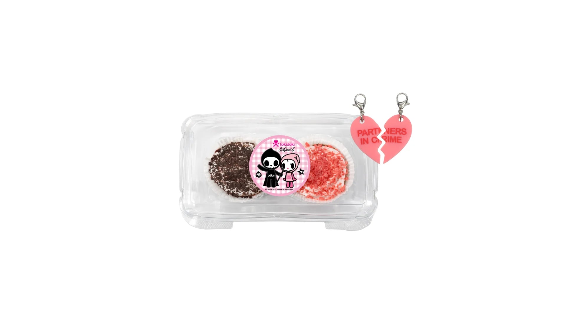 A Vanilla Cupcake Topped with Marshmallow Whipped Frosting and Chocolate Crunch & a Chocolate Cupcake Topped with Marshmallow Whipped Frosting and Strawberry Crunch in a clear cupcake container. Includes a Perfect Duo Heart Charm that Splits for Sharing.