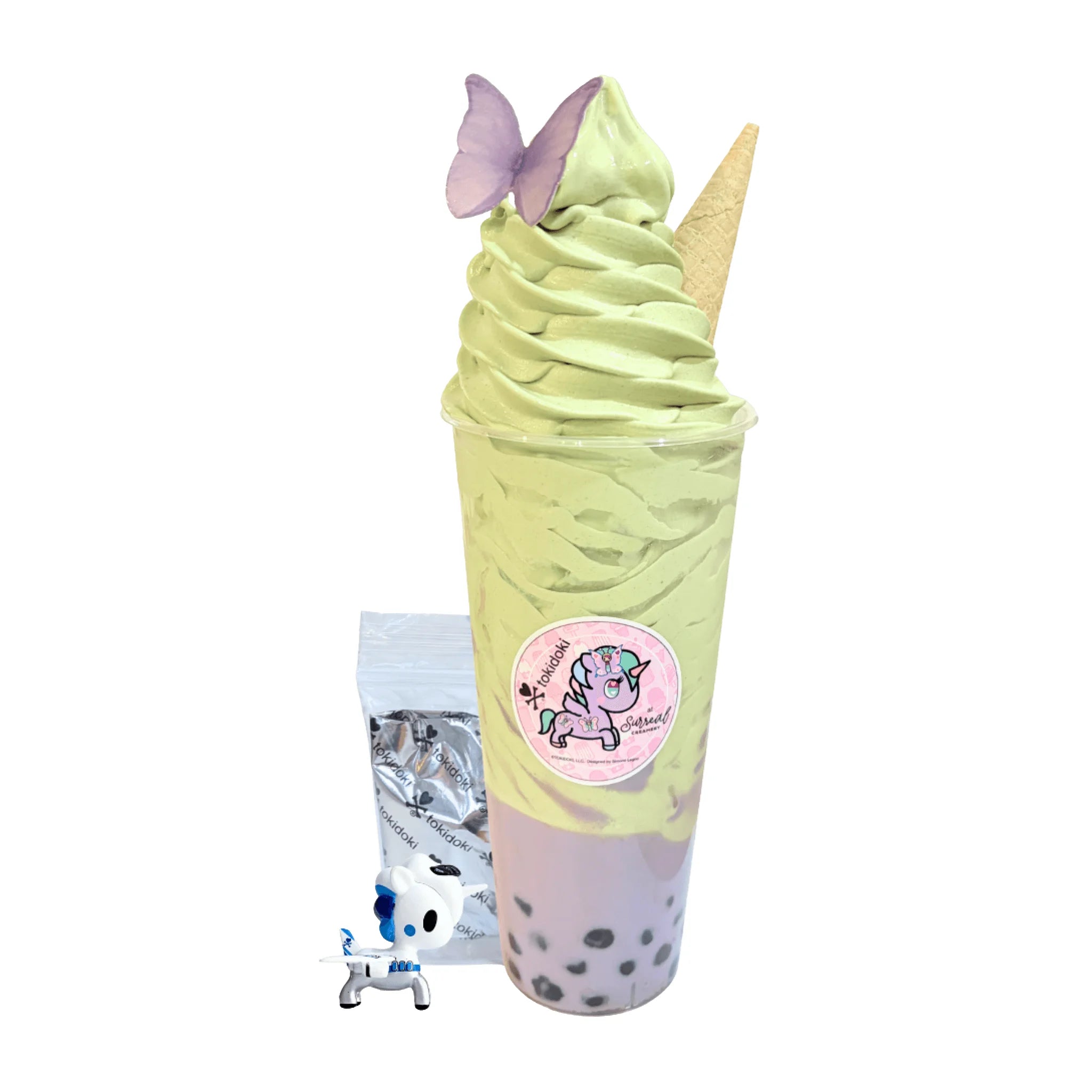 Taro Bubble Tea Topped with Matcha Soft Serve Ice Cream and a Butterfly Wafer. Comes with a 1” tokidoki Mystery Collectible. 