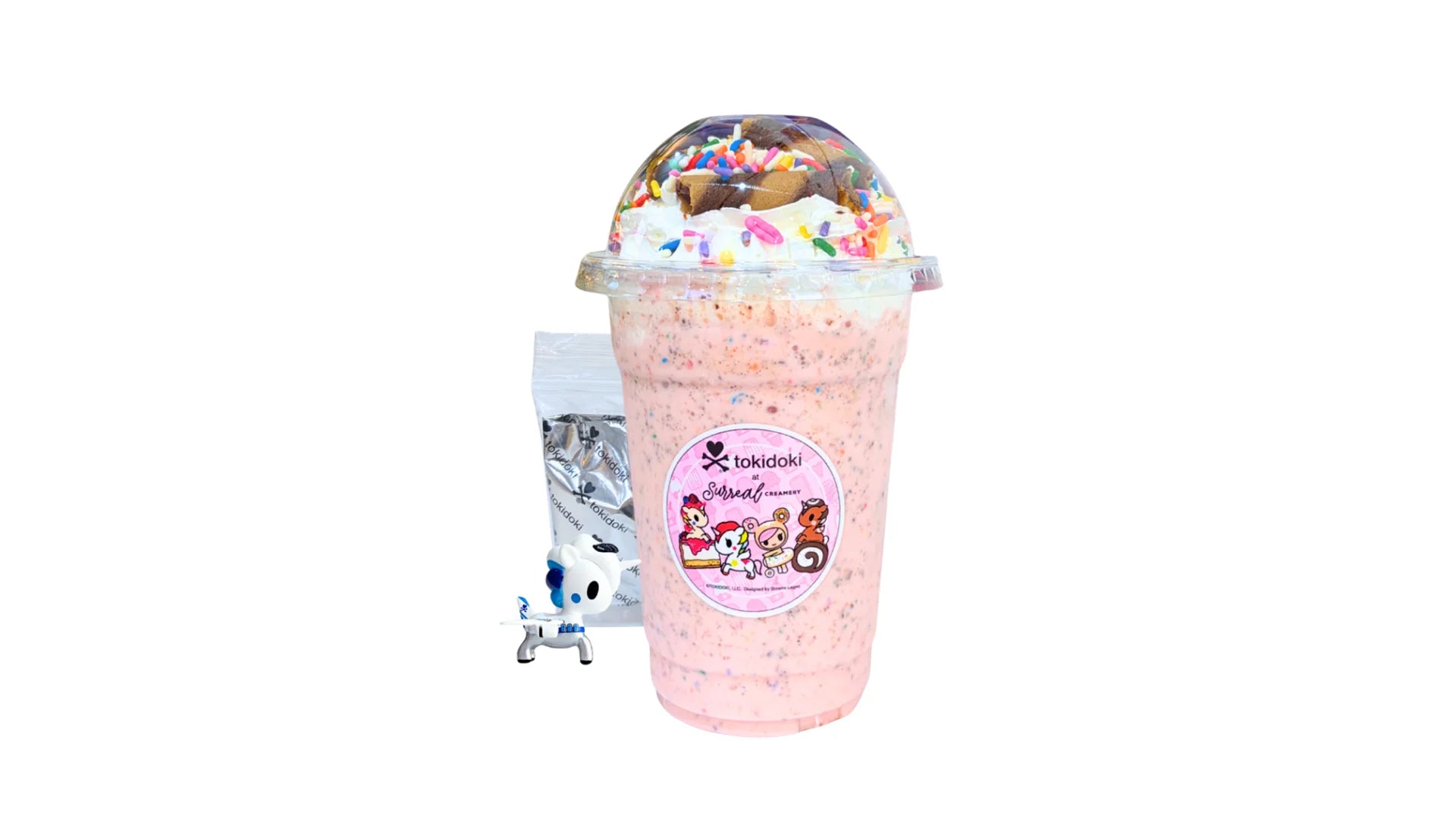A tokidoki inspired Milkshake with Strawberry Ice Cream, Chocolate Syrup, Whipped Cream, Rainbow Sprinkles and Chocolate Straws. Comes with one 1" tokidoki mystery collectible.