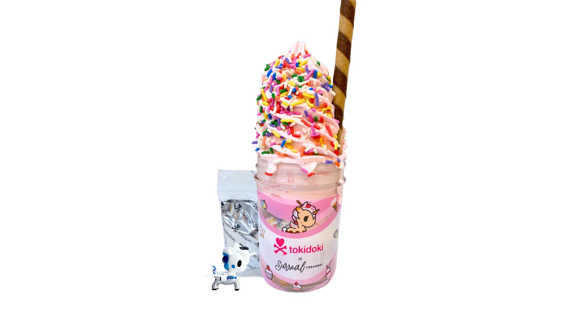 A tokidoki inspired Breaking Batter Ice Cream Cake Jar with Vanilla Cake, Strawberry Frosting, Starry Sprinkles and Strawberry Ice Cream. Served in a limited-edition mason jar and paired with one 1" tokidoki mystery collectible.