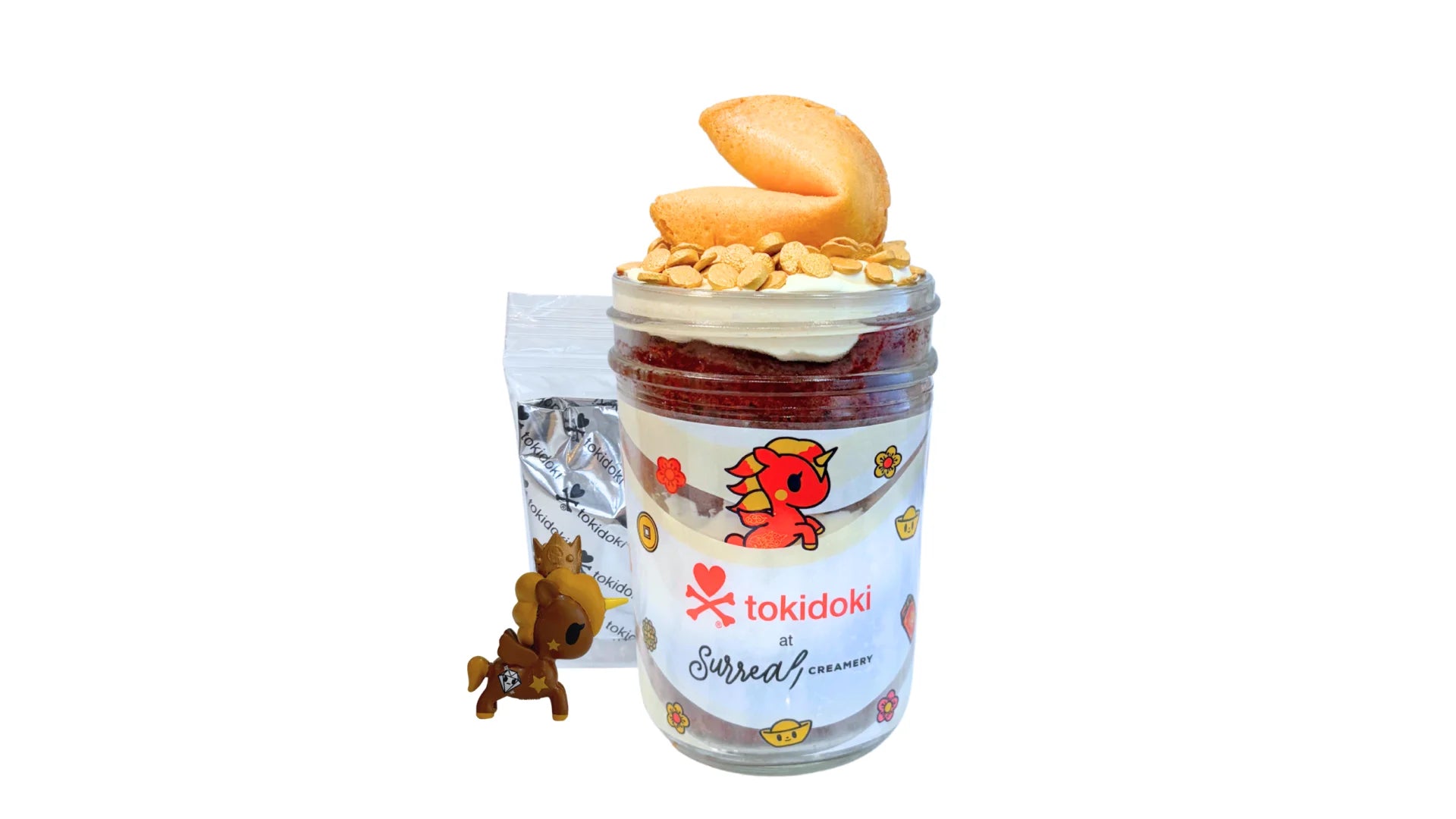 A tokidoki inspired Breaking Batter Cake Jar with Red Velvet Cake, Cream Cheese Frosting, Golden Sprinkles and a Fortune Cookie. Served in a limited-edition mason jar and paired with one 1" tokidoki mystery collectible.